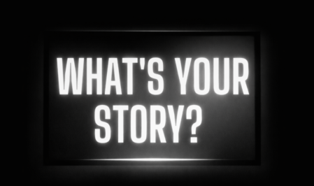 Bold illuminated text asking “What’s your story?” representing brand storytelling and content strategy in digital media marketing
